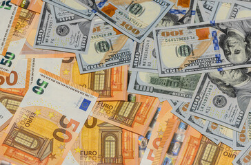 Obraz premium Hundred Dollar and Fifty Euro Banknotes as Money Background