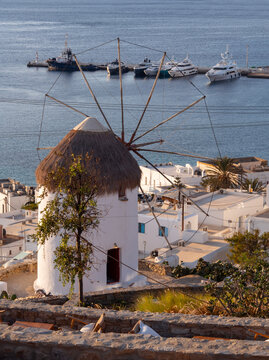 View of Chora, mills, cruise ships and sunset on the Aegean Sea on Mykonos island in Greece
