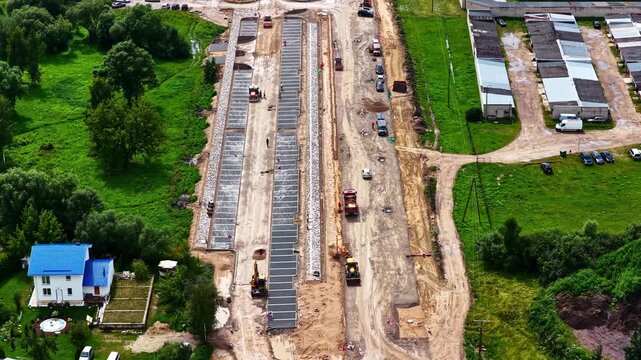 Road and railway tracks under development near residential buildings