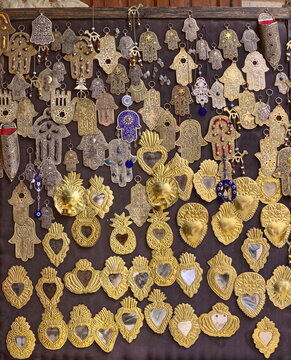 Brass and tin crafted hamsas (Fatima's hand), small hand mirrors, babouches...of a shop in the former Mellah (Jewish quarter). Marrakesh-Morocco-292