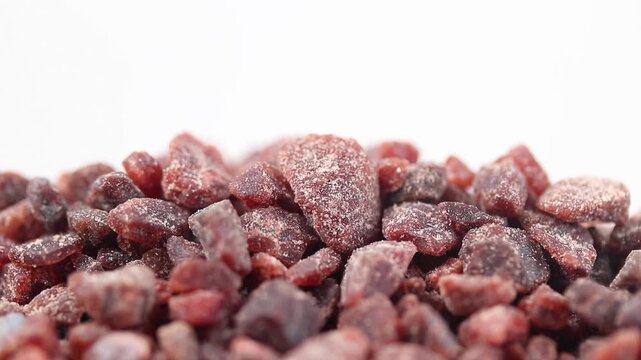 Close-up of black himalayan salt rotating slowly on a white background