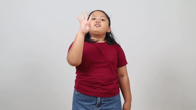 an asian little girl counts from one to ten while showing her fingers