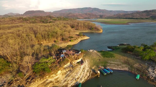 Bird flying above tropical island in Central America. 
Aerial drone view of the islands on Lago Suchitlan in El Salvador. The Cerr&oacute;n Grande Reservoir, also known locally as Lake Suchitl&aacute;n