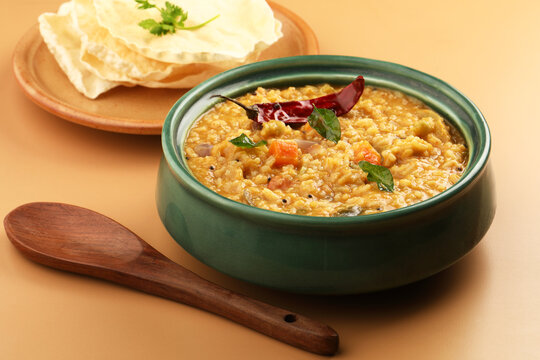 Sambar Rice - Tasty and popular south indian recipe served in a ceramic bowl with appalam or papad