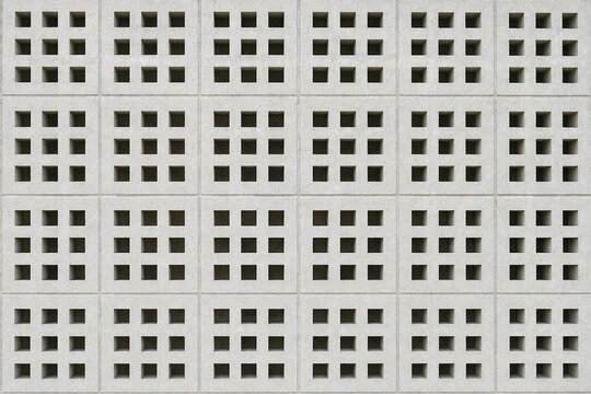 Square roster block texture with hollow grid pattern and rough concrete surface. Ideal for backgrounds, ventilation walls, and architectural design.