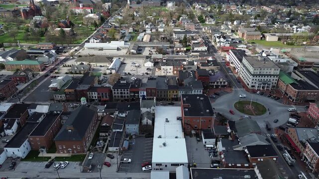 Downtown Gettysburg Lincoln Square anchors frame with Baltimore Street Chambersburg Street radiating from roundabout. Brick roofs, sharp shadows, mixedtone sit under clear light in PA