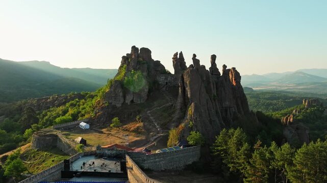 Majestic rock formations ancient fortress Belogradchik Bulgaria sunrise. Aerial perspective balkan mountain range soft morning light drone photography heritage travel destination.