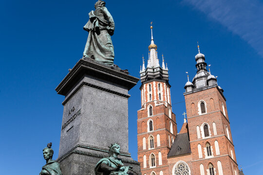 Adam Mickiewicz Monument  and Kosciol Mariacki, Bazylika Mariacka, (The St Mary Church, Saint Mary's Basilica) at the Main Market Square in Krakow, Krakow Old City, Krakow, Cracow, Poland