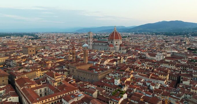 Aerial panorama Florence Italy Duomo Cathedral skyline sunset. Iconic renaissance architecture Santa Maria del Fiore dome city view. Summer travel tourism destination drone photography exploration lan