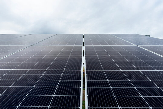Solar panels generating clean energy under cloudy sky in poland