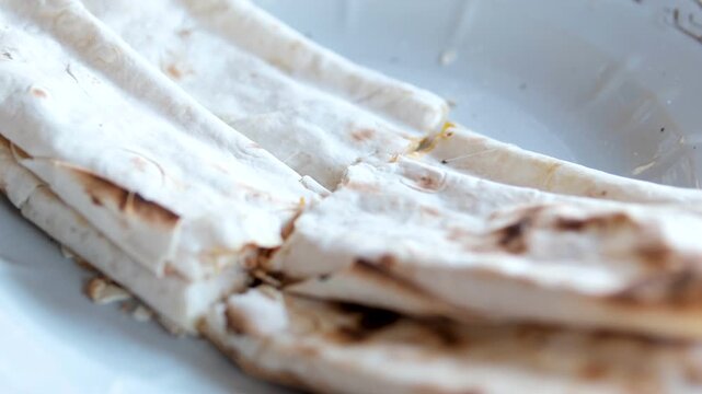 the process of cooking pita bread on the grill pita bread with cheese and yellow tomato cook fry wrap.