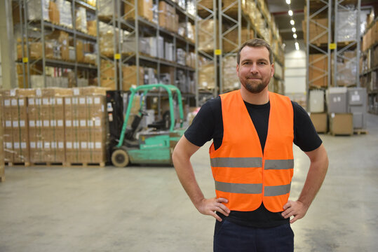 warehouse worker in a forwarding agency - interior with forklift - transport and storage of goods