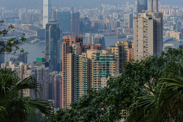 Obraz premium 20 April 2026 Down View of Residential and Commercial buildings and Victoria Harbour in Hong Kong HK in china. The Blue Skies and blue harbour is so Beautiful with view of Tsim Tsa Tsui commercial CBD