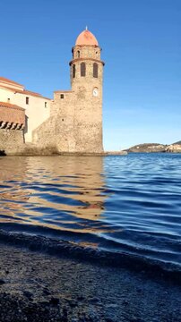 Video taken on the beachfront in Collioure, showing the church tower of Collioure