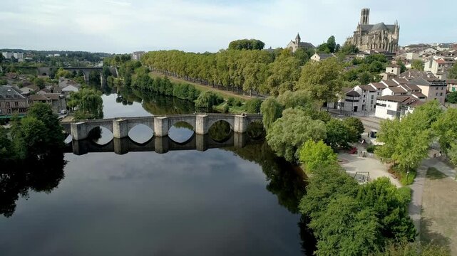 Vienne river revealing the historic Saint-Martial bridge of Limoges. Smooth drone movement.