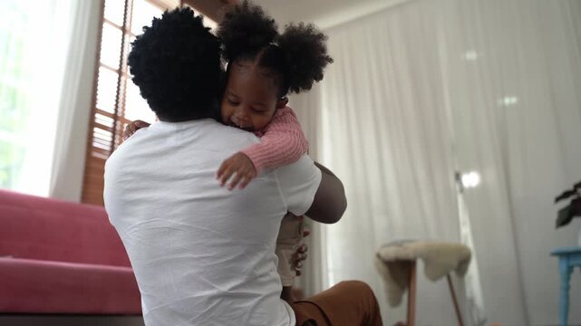 Father and daughter share a tender hug, expressing love and connection at home