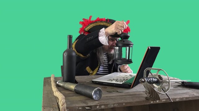 Elderly pirate in a feathered hat lifts a lantern to inspect a laptop with comedic confusion. Old-world costume meets modern technology on a green screen background
