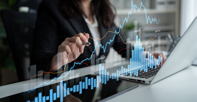 A professional analyzes financial data on a laptop, visualizing growth through graphs and charts, representing business strategy and investment insights in an office setting. Scalp