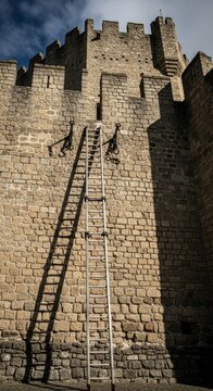 Siege Ladder Against Ancient Stone Fortification Wall