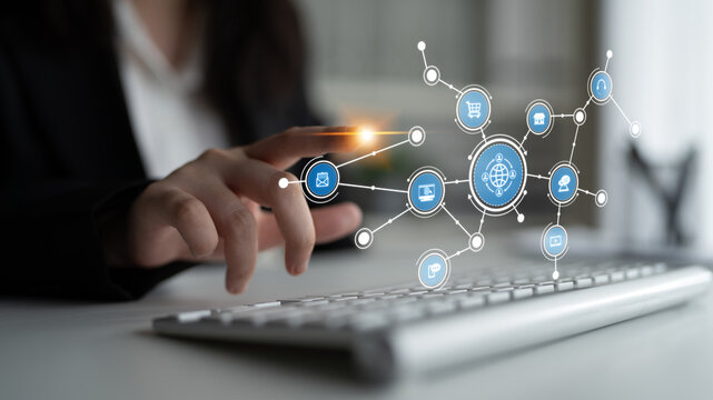 A professional individual interacts with a keyboard while connected to digital network icons, showcasing modern technology and communication in a contemporary workspace. Tessel