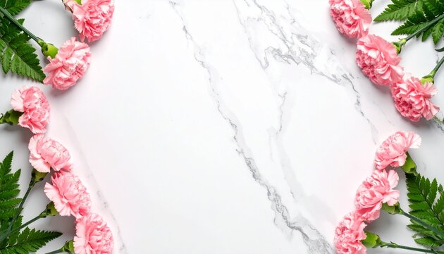 Pink carnation flowers and green leaves border on white marble background with copy space