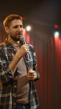 Vertical Screen. Male Comedian Closes a Live Stand-up Comedy Club Performance on Stage at an Open Mic Night, Telling Funny Jokes as the Audience Is Having Fun in a Bar Venue Entertainment Show Finale.