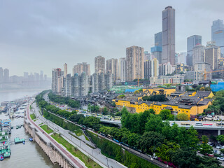 Fototapeta premium Chongqing China Metropolis filled with mountains and high-rise buildings on the Yangtze and Jialing Rivers. At night transforms into beautiful and colourful light shows on the river banks
