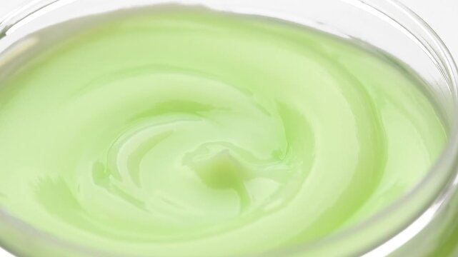 Cream texture, natural cosmetics, face, body green moisturizing gel, skin care, hydrating hair vegan mask background, aloe vera cosmetic product backdrop, top view, rotating, slow motion
