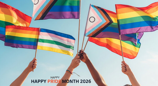 Rainbow and progressive pride flags held against a clear blue sky, symbolizing pride, diversity, and inclusion, with text "HAPPY PRIDE MONTH 2026"