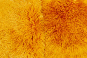 Fototapeta premium Bright yellow fur texture showing soft fibers in close detail on a flat surface during daylight