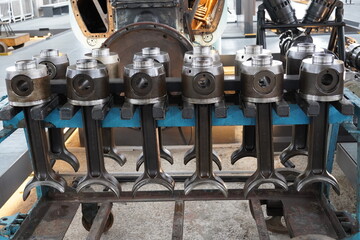 Symmetrical row of heavy duty locomotive diesel engine pistons © YiChuan