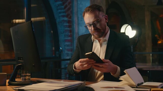 Multitasking business man in evening dark office talking phone with papers review Caucasian businessman male guy busy entrepreneur leader at night working with documents answer smartphone mobile call