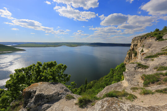 Scenic Dnister river canyon with rocky cliffs and green hills under a blue sky