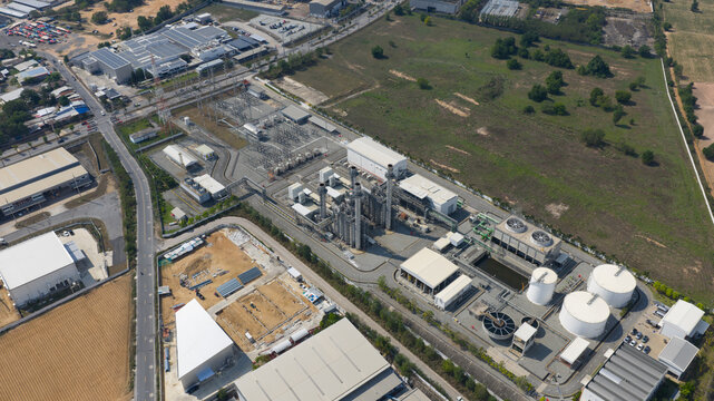 Aerial view of Amata B.Grimm Power Rayong 5 power plant featuring electrical substations, cooling towers, and industrial infrastructure in Map Yang Phon, Rayong, Thailand.