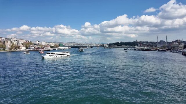 Scenic Daytime View of Istanbul Golden Horn with Passenger Ferries, Galata Bridge, Historic Mosques and Beautiful Clouds over the Bosphorus Strait, Turkey - Aerial Style Fixed Shot
