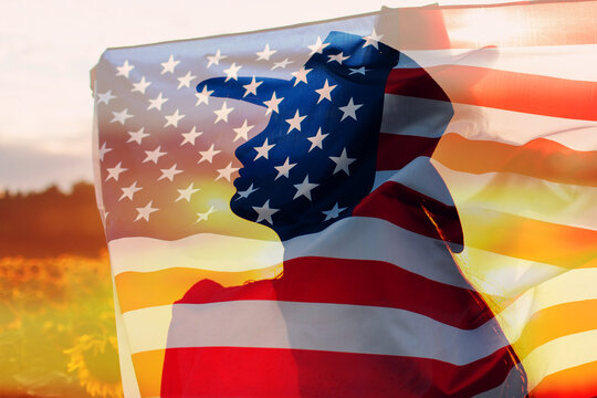 Woman in cowboy hat silhouette with the American Flag inside her head. 4th July celebration concept. Double exposure image.
