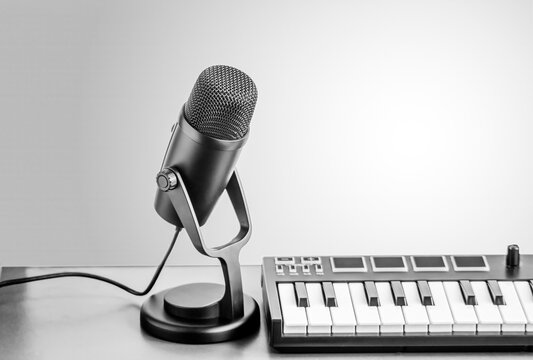 Desktop microphone with MIDI keyboard in studio setup