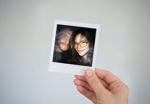 Instant Photo in Clean Woman&rsquo;s Hand on Grey Background Mockup