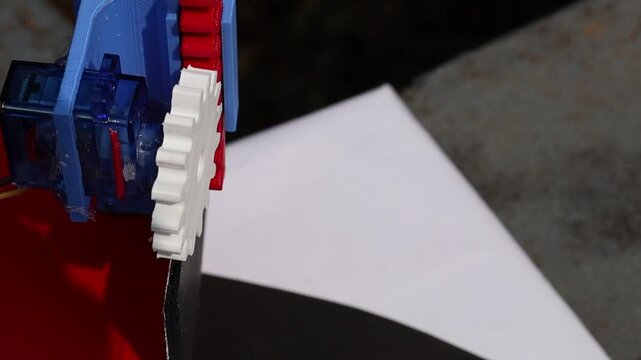 View of gear connected to shaft of the micro servo moving the slider mechanism. Mechanical movements using 3d printed parts