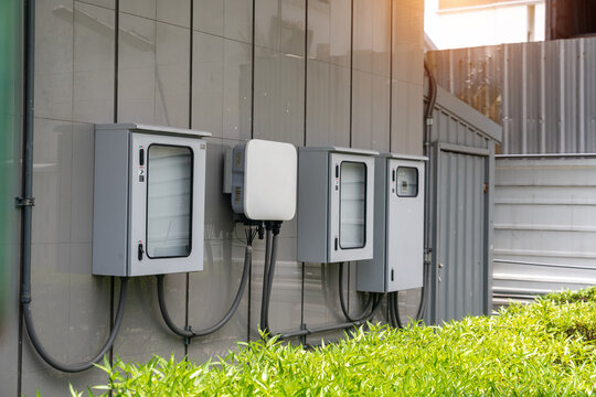 Modern Electrical Utility Boxes and Metering Devices Mounted on Exterior Wall