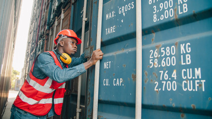 Worker container industry logistics shipping safety warehouse transport cargo port Confident male worker wearing safety vest and helmet stands between large cargo container industrial shipping © chokniti