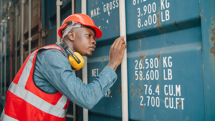 Worker container industry logistics shipping safety warehouse transport cargo port Confident male worker wearing safety vest and helmet stands between large cargo container industrial shipping © chokniti