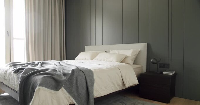 minimalistic scandinavian style of interior. Elegant and Simple Bedroom With a King Sized Bed. Interior with wood on the wall. Real Estate. Interior of modern luxury bedroom with furniture.