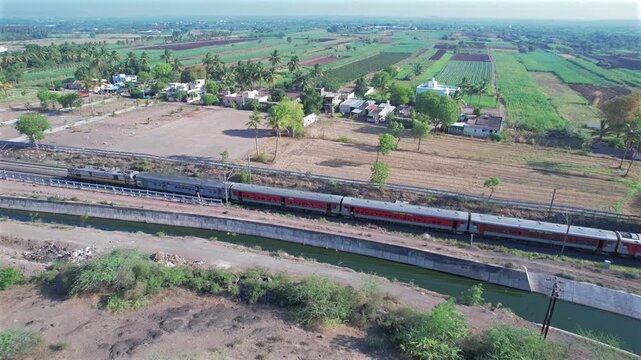 Passenger train hauled by a WAP7 electric locomotive near Pune India.