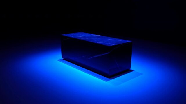 Vivid Blue Rectangular Object Shines Brightly On Dark Studio Floor With Smoke And Lighting Effects