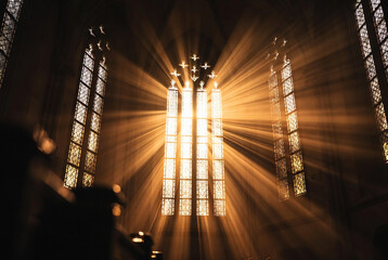 Fototapeta premium Subject: A stained-glass window in a cathedral. Action: Light streams through the windows, creating an ethereal effect. Setting: Inside a large, historic church.