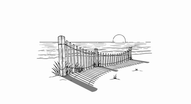 Wooden fence on beach with water and sunset in the background