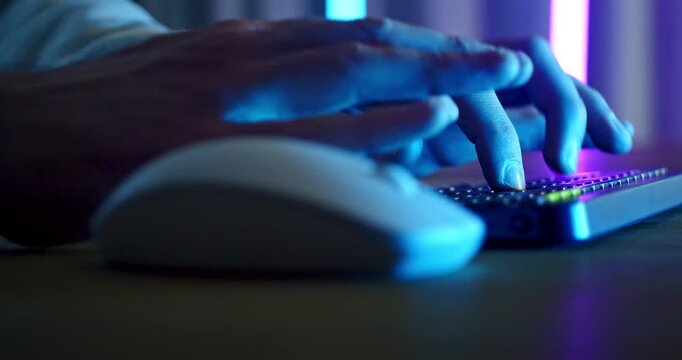 Slow Motion Of Hands Using Computer Mouse And Keyboard With Neon Blue Lighting, Modern Technology Workspace And Digital Productivity Concept