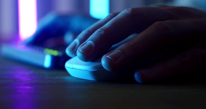 Close Up Of Hands Using Computer Keyboard And Mouse With Neon Blue Lighting, Creative Designer Working Late At Night In Digital Studio
