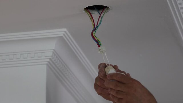 Ceiling wiring installation. connecting ceiling lighting .High quality 4k footage